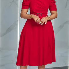 A woman wears a red, short-sleeved, A-line midi dress with a belted waist.