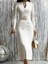 A fitted white long-sleeve V-neck dress with a decorative belt and gold-tone button accents.