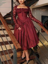 A burgundy long-sleeved dress with lace detailing, a square neckline, and a full pleated skirt.
