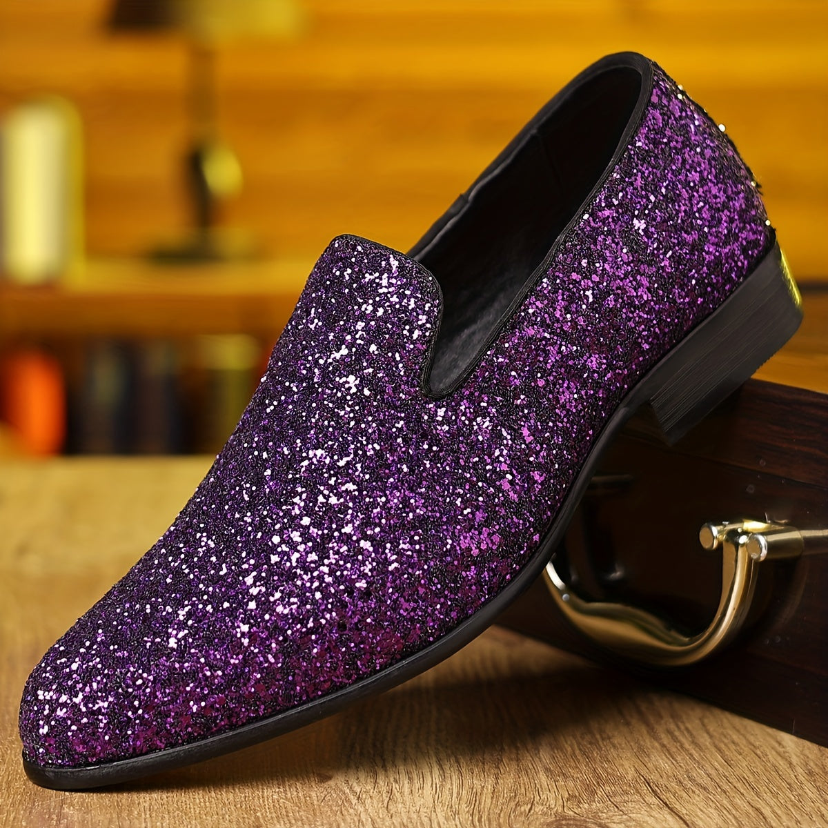 A purple glitter slip-on dress shoe with a pointed toe and black sole.
