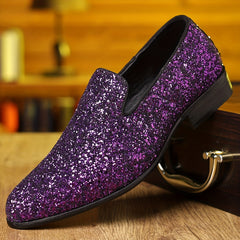 A purple glitter slip-on dress shoe with a pointed toe and black sole.