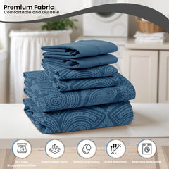 A stack of blue paisley patterned microfiber sheets sits on a white surface.