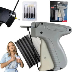 A grey clothing tagging gun with a set of needles and plastic fasteners for fabric repairs.