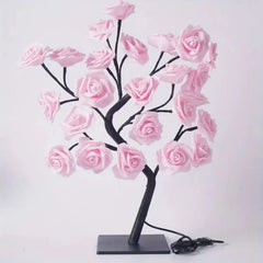 A decorative rose tree lamp with pink flower blossoms on adjustable black branches.