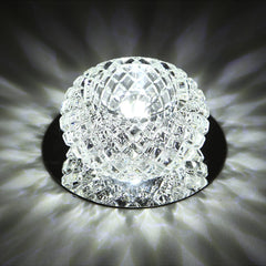 A round, faceted crystal LED ceiling light fixture with a reflective stainless steel base.