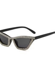 Black cat-eye sunglasses with a rhinestone-encrusted frame and dark lenses.