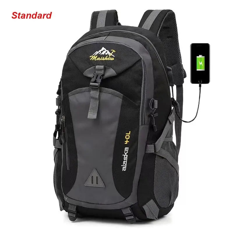 The Anti-theft Mountaineering Waterproof Backpack, designed for men, features a black and gray design, large capacity with multiple pockets, phone charging capability, durable nylon material, and “Standard” in red at the top left.