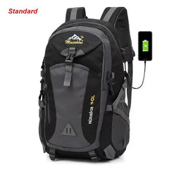 The Anti-theft Mountaineering Waterproof Backpack, designed for men, features a black and gray design, large capacity with multiple pockets, phone charging capability, durable nylon material, and “Standard” in red at the top left.