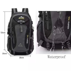 The Anti-theft Mountaineering Waterproof Backpack for men, shown in black and gray (53x30x19cm), demonstrates its water resistance as liquid pours off the nylon surface. "alaska 40L" highlights its spacious capacity for outdoor activities.