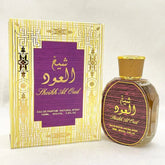 A bottle of Sheikh Al Oud perfume stands next to its yellow and purple decorative box.