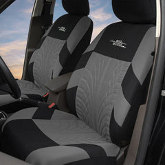 Two grey and black polyester car seat covers with a tire tread pattern installed in a vehicle.