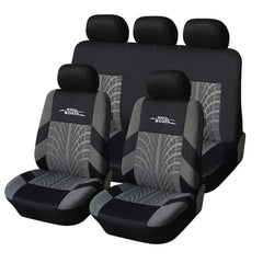 A full set of black and grey polyester car seat covers featuring a tire tread pattern design.