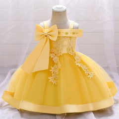 The Bow Summer Dresses Infant Baby Girl Birthday Party Dress features a sleeveless yellow design with a large shoulder bow, floral lace embroidery bodice, and flared layered skirt, beautifully displayed on a mannequin.