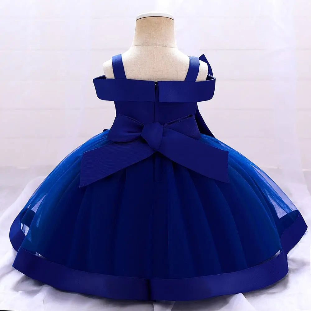 A child-sized mannequin displays the Bow Summer Dresses Infant Baby Girl Birthday Party Dress—a sleeveless deep blue gown with a full tulle skirt and large back bow—against a light, neutral background.