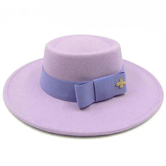 A light purple flat-top fedora hat featuring a matching ribbon band with a gold bee emblem.