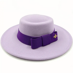 A light purple felt fedora hat with a dark purple bow band and a gold bee emblem.