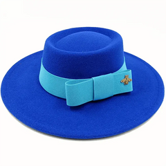 A bright blue flat top fedora hat featuring a light blue ribbon bow and a gold bee emblem.