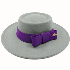 A grey felt fedora hat with a flat top, featuring a purple ribbon band and a gold bee emblem.