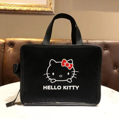 A black canvas Hello Kitty handbag with a red bow and white lettering on the front.