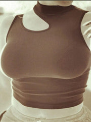 A person models the Chic Off-Shoulder Crop Top, a sleeveless, form-fitting piece with a stylish cut-out neckline. The photo has a sepia or inverted filter, focusing on the top and omitting the person's face for modern summer flair.