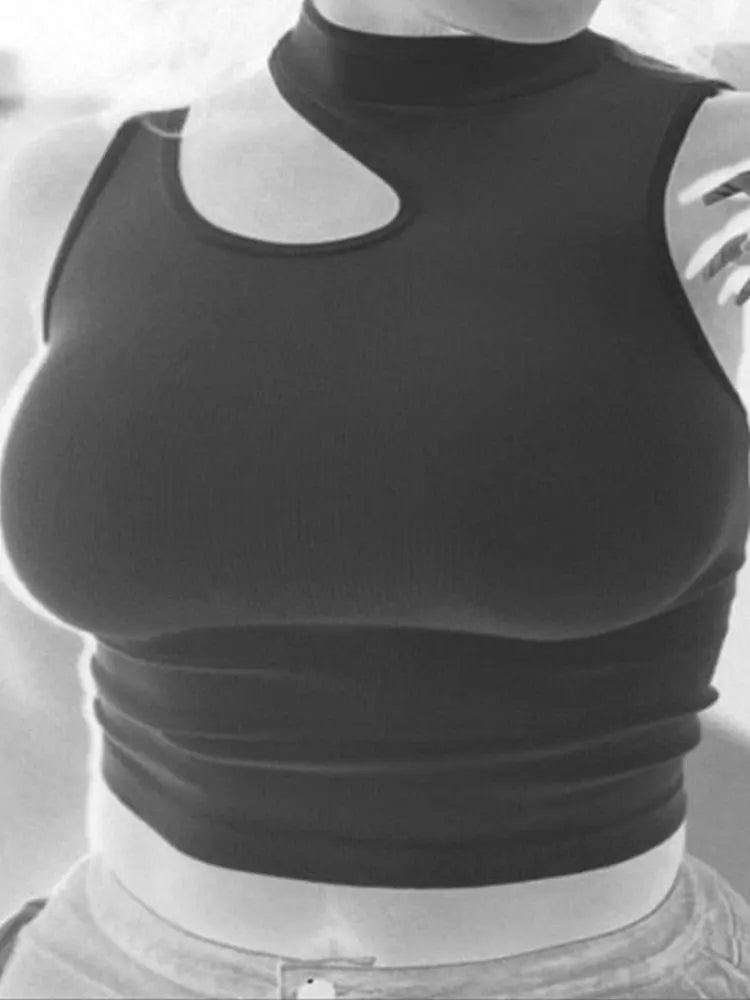 A person wears the Chic Off-Shoulder Crop Top, a dark, sleeveless summer style with an asymmetrical cut-out near the neckline. The black and white photo with a negative effect shows only their upper torso.