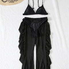 A black three-piece bikini set featuring a triangle top, bikini bottoms, and ruffled sheer trousers.