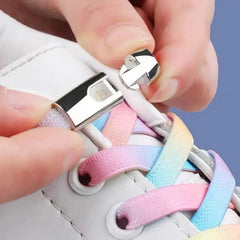 A close-up of hands fastening Cross buckle Elastic No Tie Shoelaces for Sneakers, featuring pastel rainbow colors and a silver clasp on a white sneaker, set against a blue background.