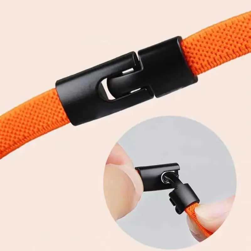 Close-up of an orange Cross buckle Elastic Shoelace No Tie for Sneakers, featuring a black plastic locking connector, shown attached and also separated by two fingers in a circular inset.