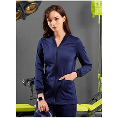 A woman wears a navy blue zip-up medical scrub jacket with ribbed cuffs and front pockets.