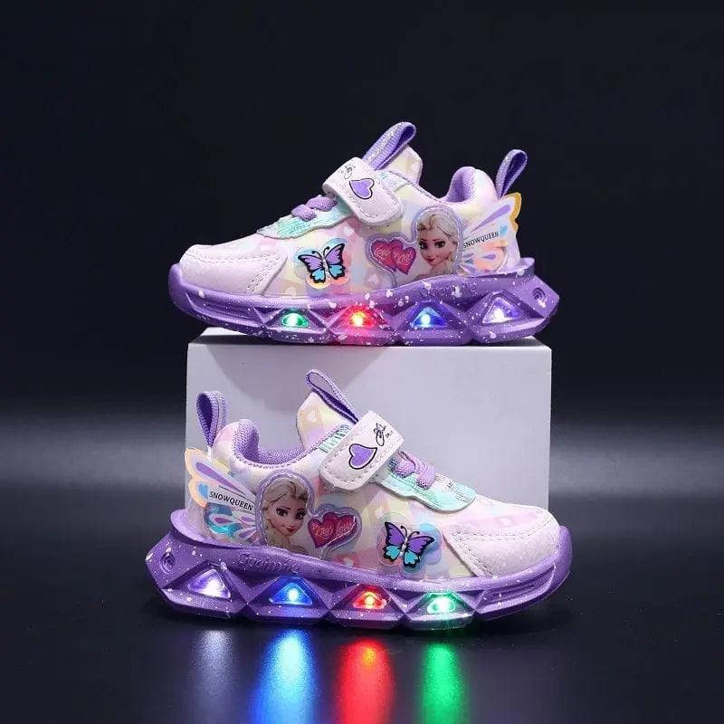 Showcased on a black background, Disney LED Casual Sneakers for girls feature a Frozen Elsa princess print, purple soles, butterflies, multicolored LED lights, and PU leather. One pink-and-purple pair is displayed elevated on a white block.