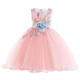 The Elegant Kids Dress is a sleeveless pink tulle princess dress for girls ages 3-10, featuring a full puffy skirt and pink, blue, and cream floral appliqués with silver leaves—perfect for birthdays, weddings, or parties.