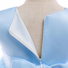 Close-up of the back of the Elegant Kids Dress For Girls Birthday Wedding Costume, showing light blue satin fabric, open zipper, large waist bow, and visible lining; ideal for girls aged 3-10 at parties or special occasions.