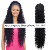 A woman wears a long, black, curly drawstring ponytail wig with a natural texture.