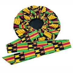 An extra large satin sleep bonnet featuring a vibrant African print and an adjustable wide band.