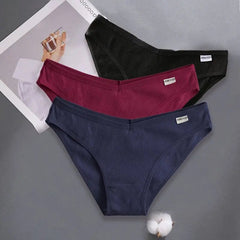 Three pairs of ribbed cotton low-rise briefs in black, maroon, and navy blue.