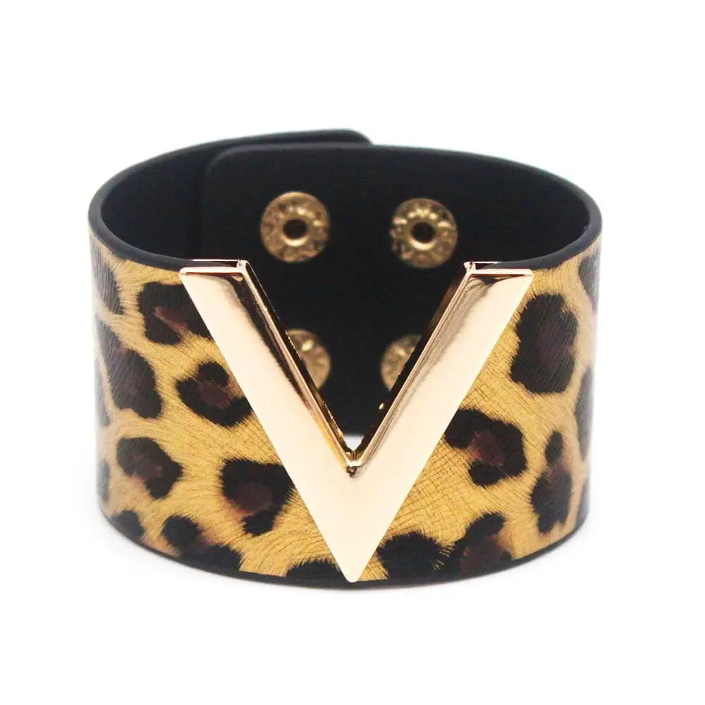 The Fashion Leopard Leather Bracelet for women features a wide cuff design, chic leopard print, gold V-shaped accent, and snap closures—a stylish all-match charm wrap wristband jewelry piece.