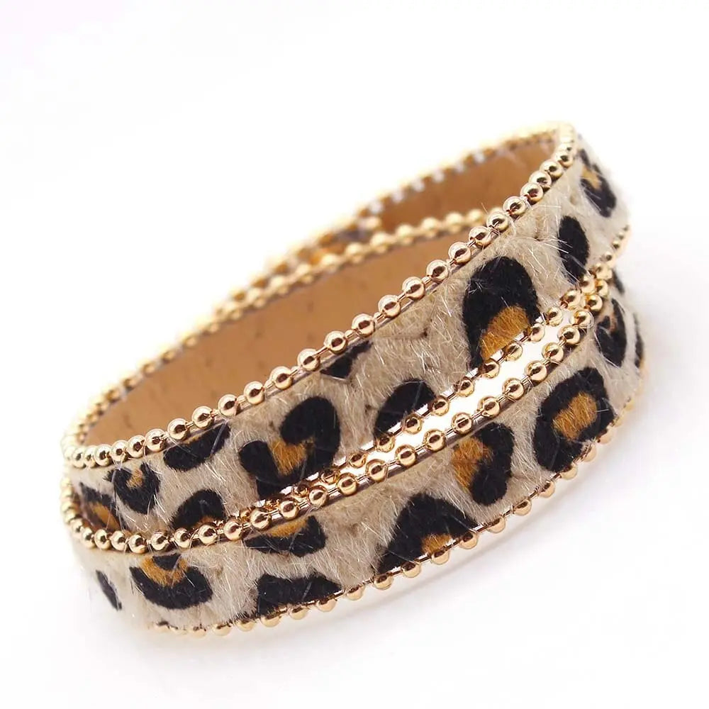 The Fashion Leopard Leather Bracelet for Women features a faux leopard print, double-layer wrap, and gold bead borders—an all-match, stylish wide cuff wristband perfect for modern fashion.