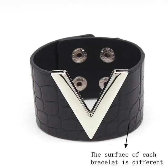 The Fashion Leopard Leather Bracelet for women features a wide band with a crocodile-like texture, a bold silver V accent, and snap closure. Each charm cuff wristband is unique due to natural leather variations.