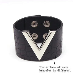 The Fashion Leopard Leather Bracelet for women features a wide band with a crocodile-like texture, a bold silver V accent, and snap closure. Each charm cuff wristband is unique due to natural leather variations.