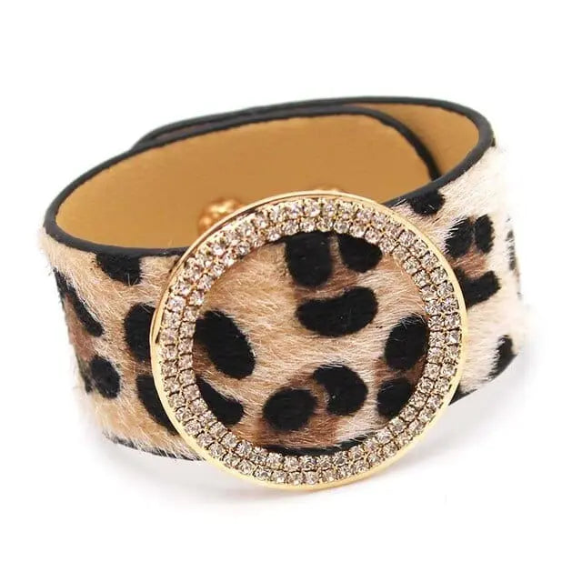The Fashion Leopard Leather Bracelet For Women features a wide leopard print design and a large gold circular buckle with sparkling crystals—a stylish and elegant charm cuff wrap wristband for women.