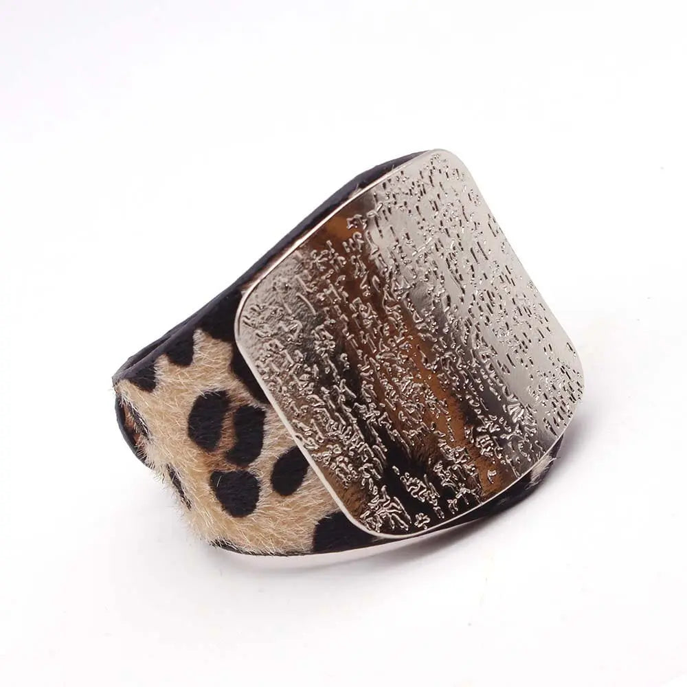 The Fashion Leopard Leather Bracelet for Women features a wide band with leopard print fur and a large textured metallic plate. This simple, all-match cuff wrap charm wristband is perfect for stylish women’s jewelry collections.