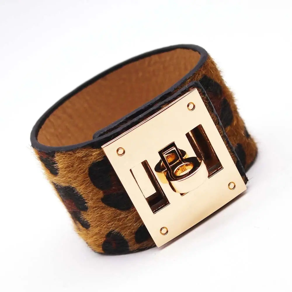 The Fashion Leopard Leather Bracelet for Women is a wide charm cuff with brown and black faux fur, accented by a bold gold-toned clasp—ideal for making a statement with any outfit.
