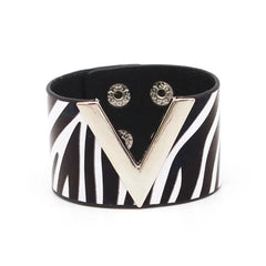 The Fashion Leopard Leather Bracelet for women features a wide black band with bold white zebra stripes and a large metallic V accent, secured by two snaps. This statement cuff is a striking, all-match accessory for any outfit.