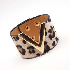 The Fashion Leopard Leather Bracelet for women features a bold leopard print, gold V-shaped accent, and snap closures—a wide charm cuff perfect for those seeking standout style.