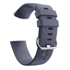 A grey silicone replacement band for a Fitbit Charge 3 with a silver buckle.