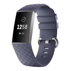 A blue Fitbit Charge 3 fitness tracker with a textured silicone band and a metal buckle.