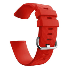 A red silicone replacement watch band for a Fitbit Charge 3 with a silver buckle.