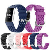 A collection of breathable silicone replacement watch bands for the Fitbit Charge 3 in many colors.