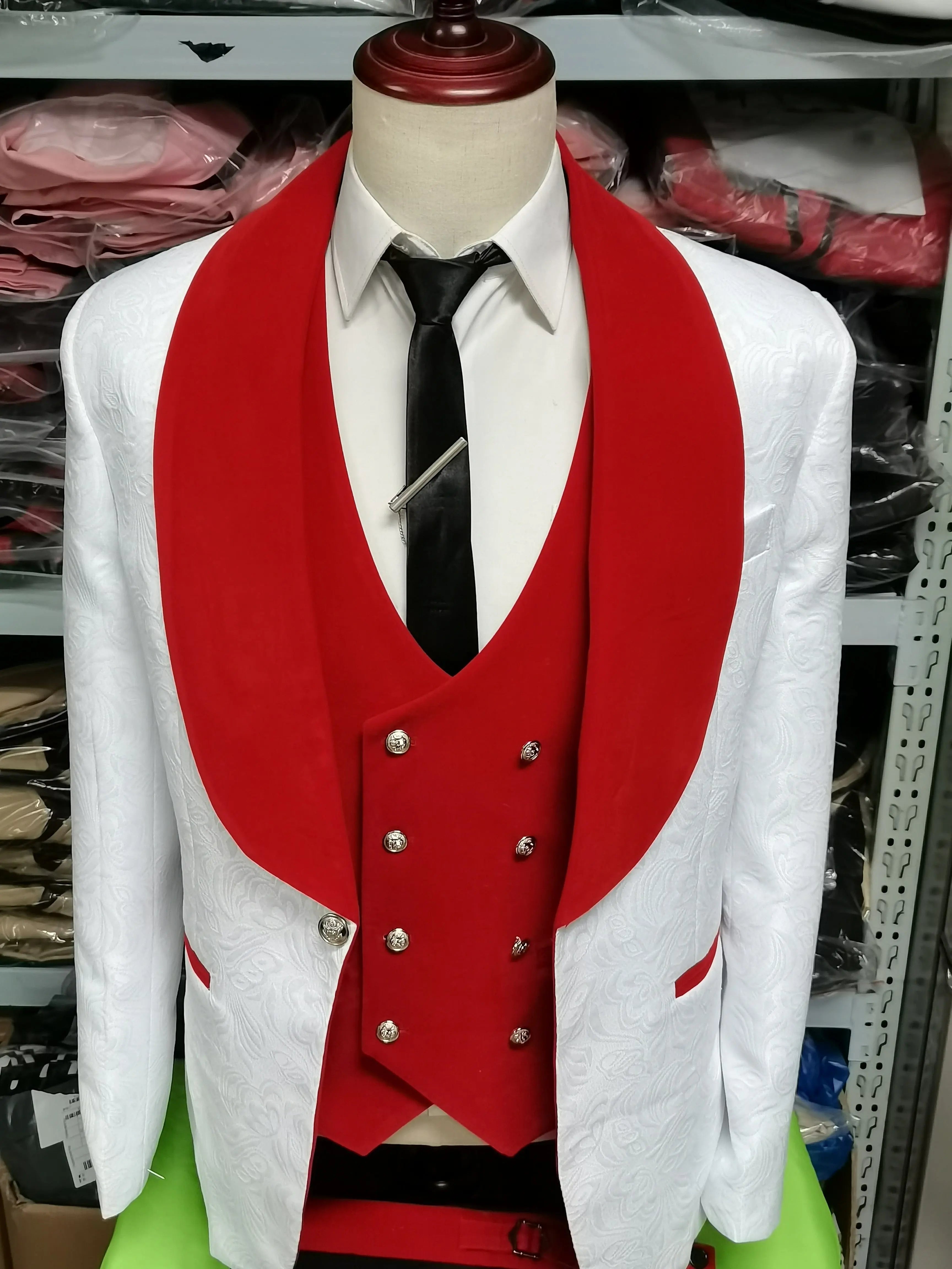 A mannequin showcases the Floral Jacket Men Suit Slim Fit—a navy blue velvet blazer with floral patterns and lapel, white shirt, red waistcoat, black tie with clip, and silver buttons—ideal inspiration for men's business suits. Clothing shelves are in the background.