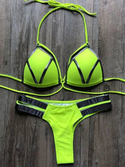 A neon yellow bikini set featuring metallic silver trim on the triangle top and side straps.